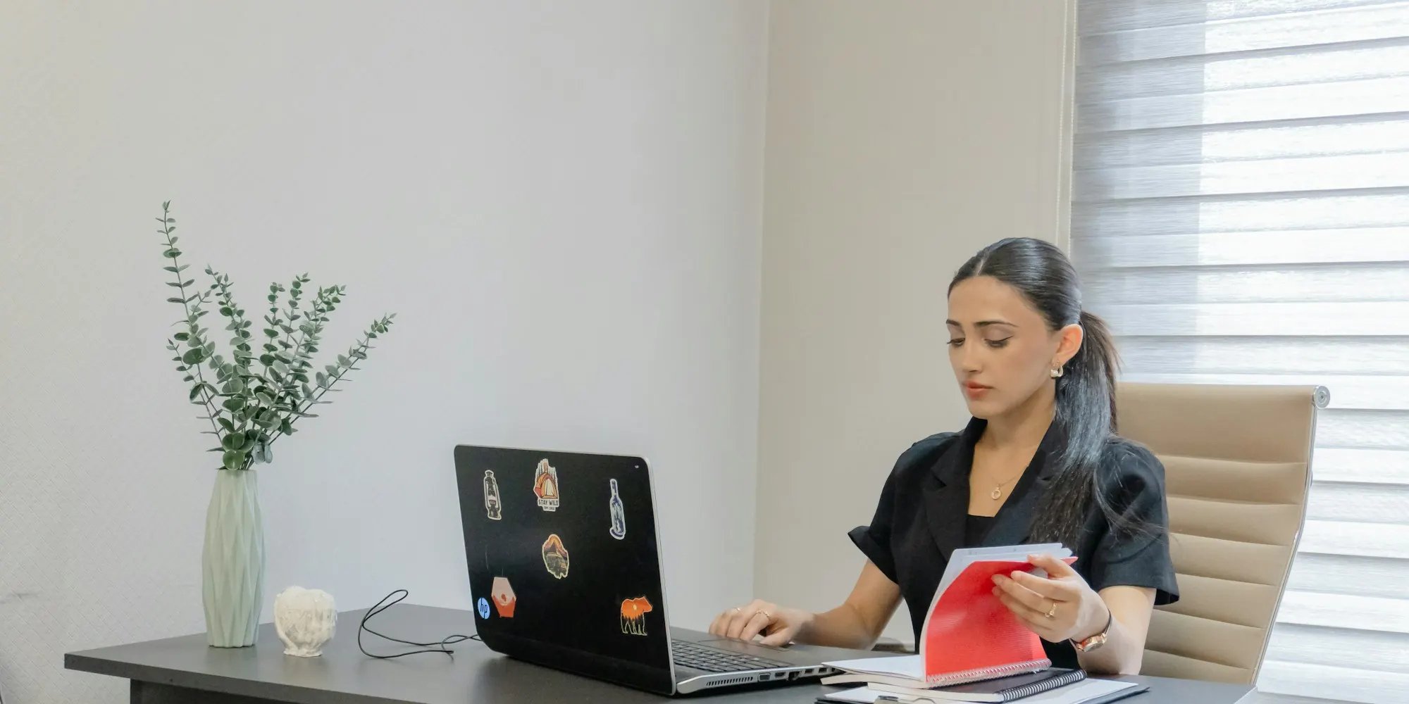 Business owner working on a laptop at her desk