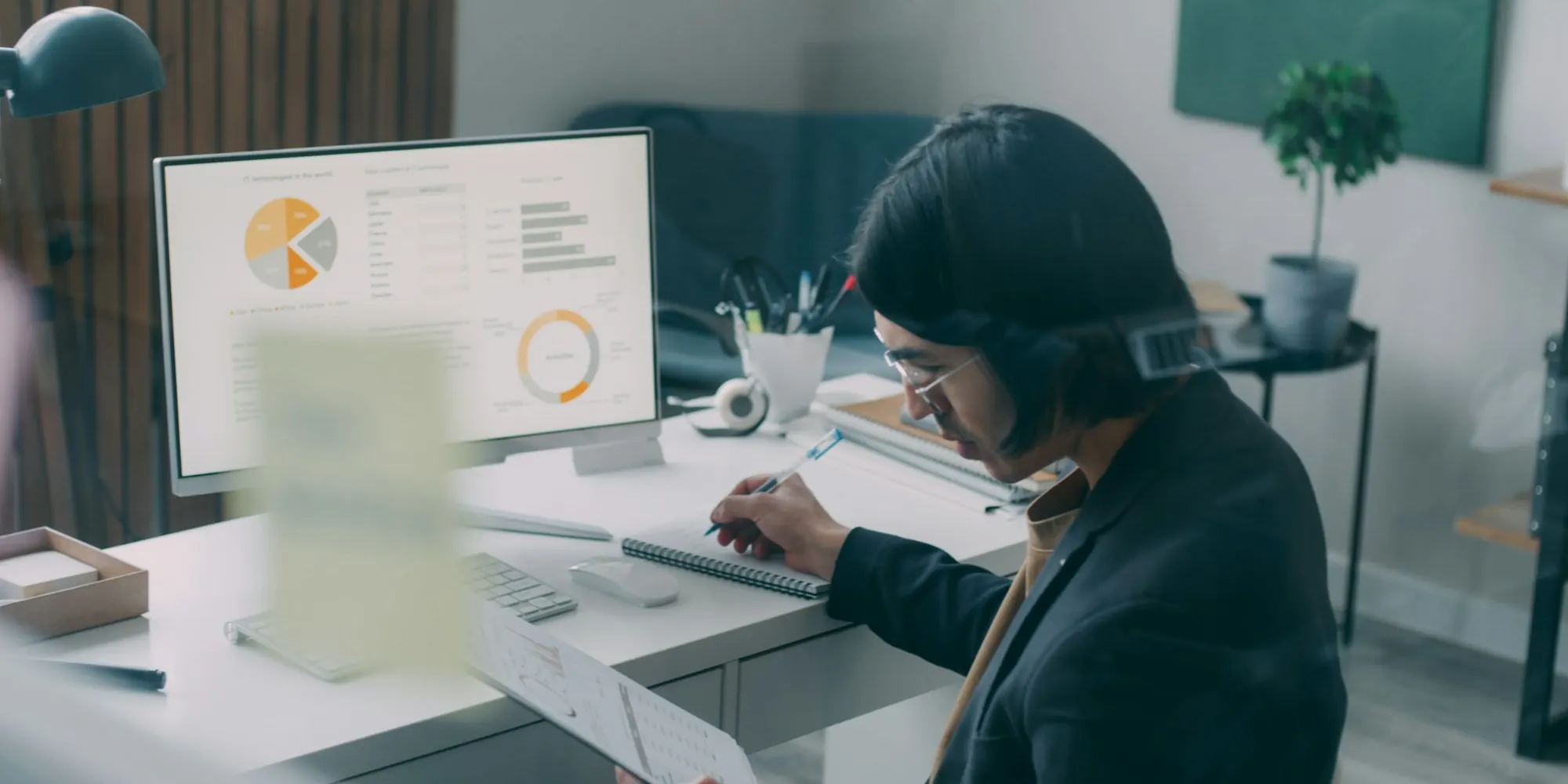 Business owner at his desk working through numbers on a computer