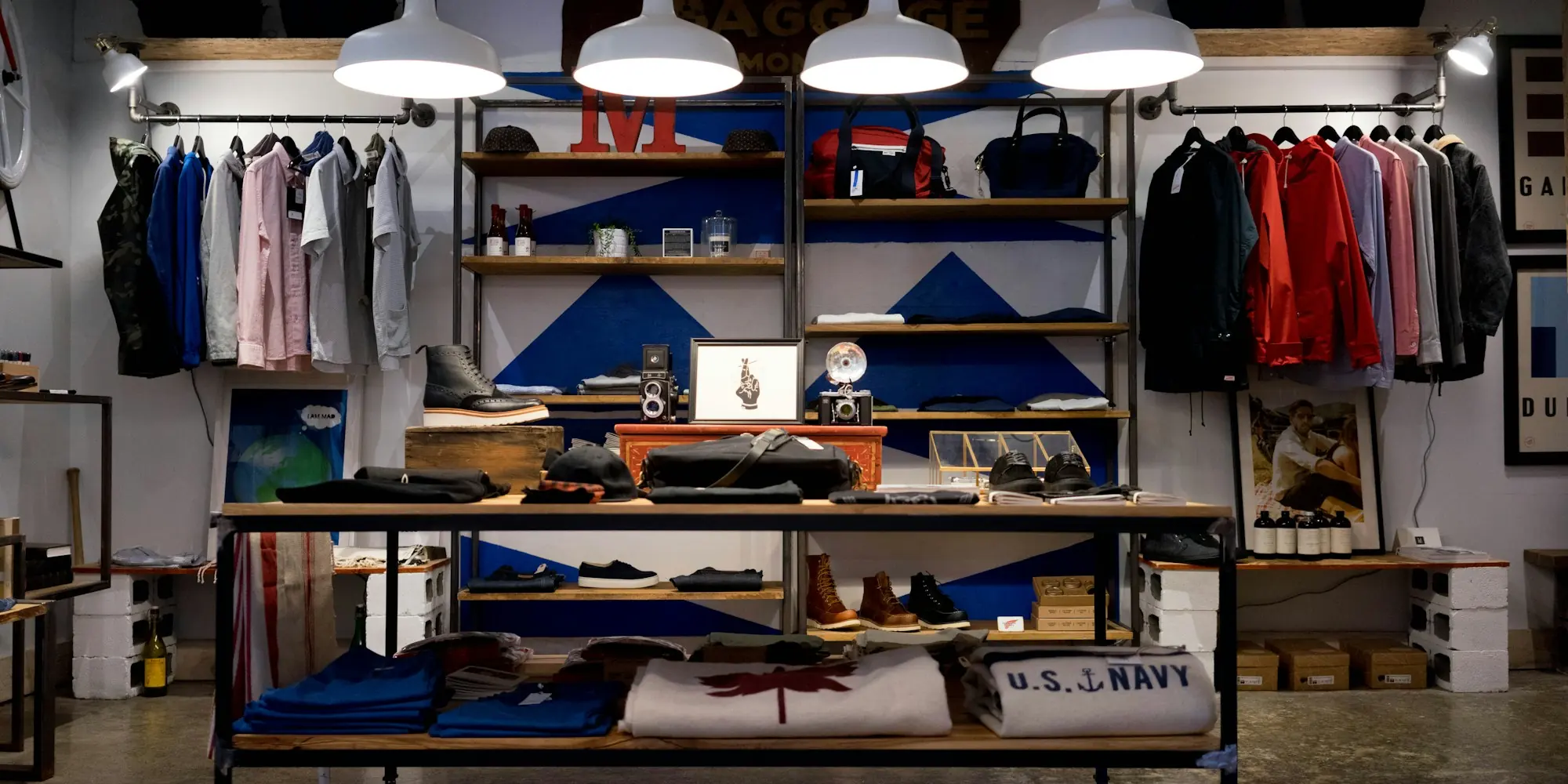 Interior of a small clothing store with racks and shelves of stock