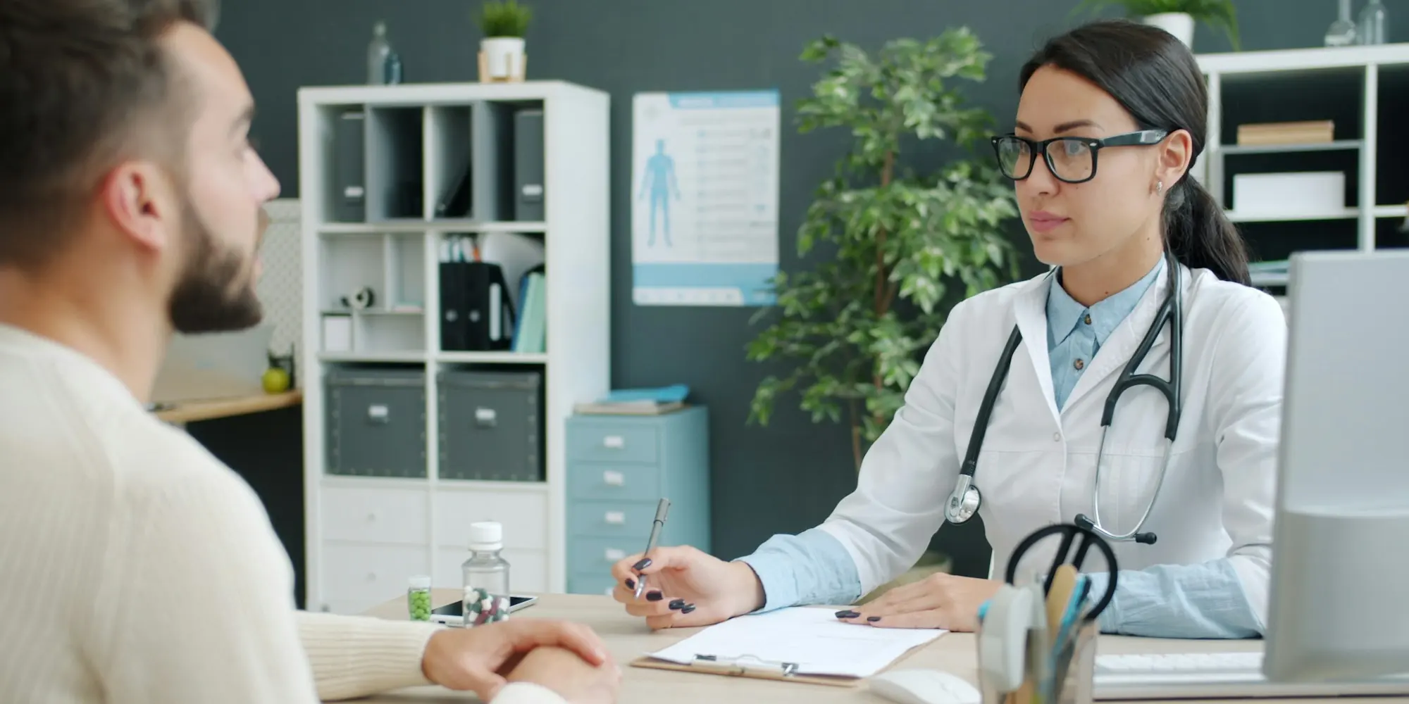 Doctor consulting with a patient across a desk in her office