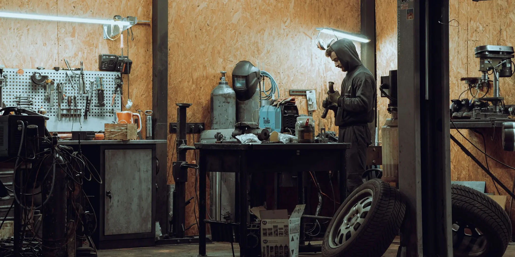 Mechanic working at a machine in an auto repair garage