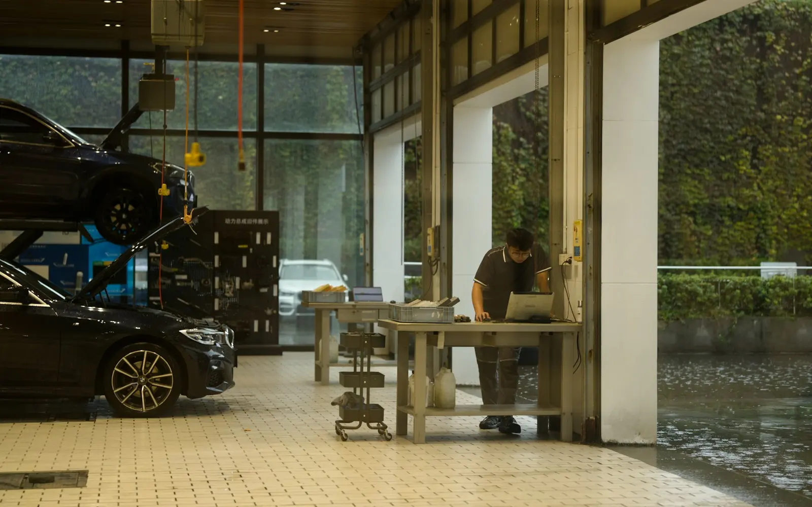 Mechanic checking a laptop in an auto repair shop