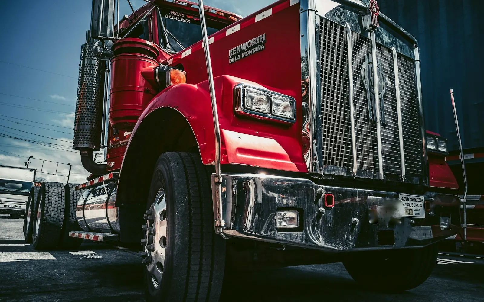 Red semi truck parked on a paved lot