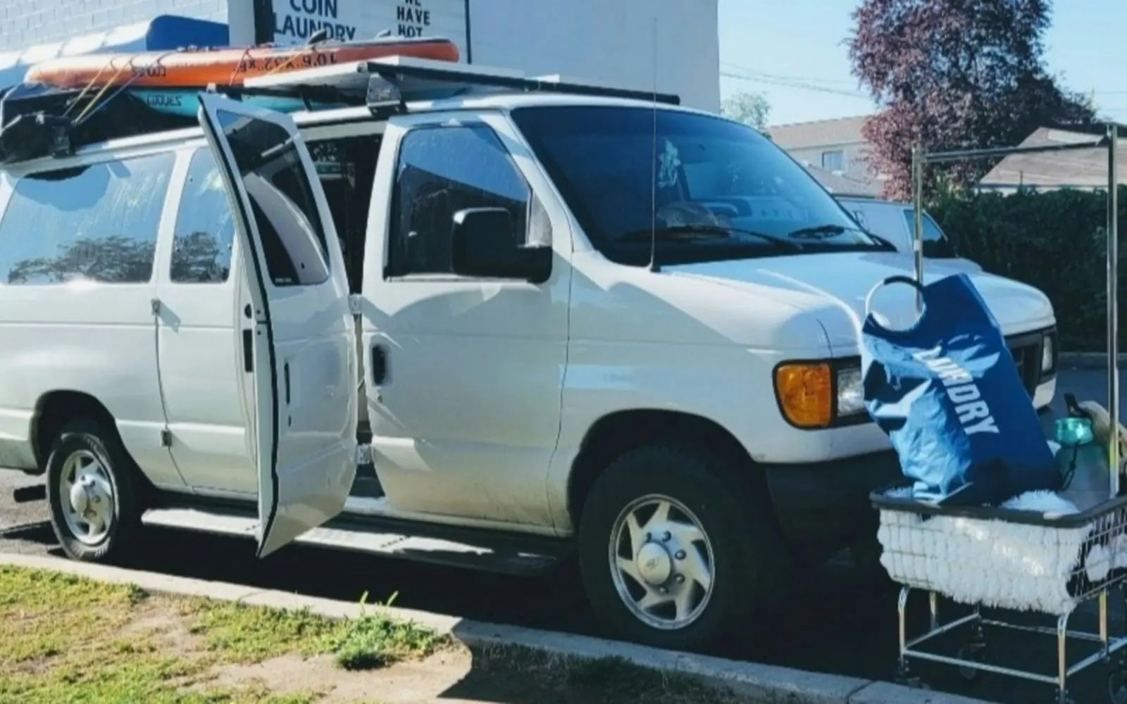 Service van parked on a street with its doors open