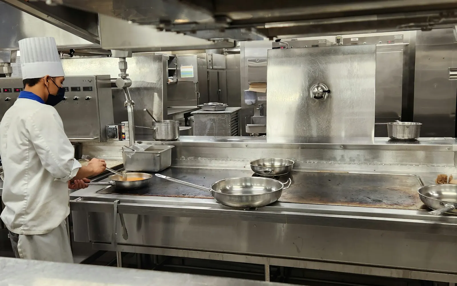 Chef cooking at the line in a busy commercial kitchen