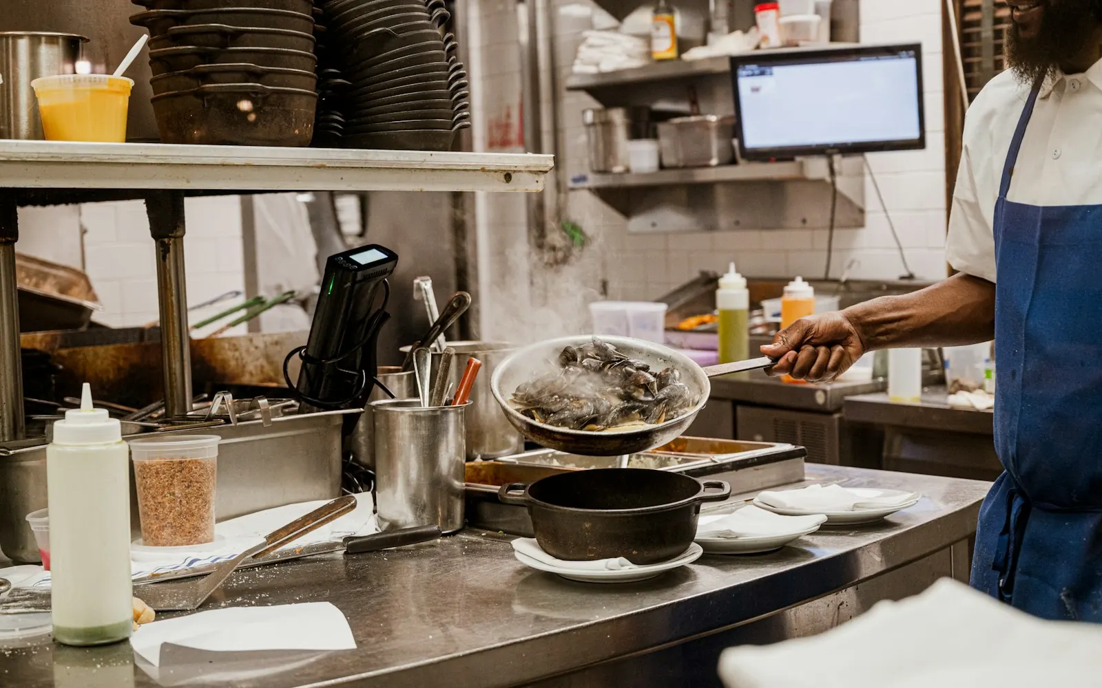 Cook preparing plates in a restaurant kitchen